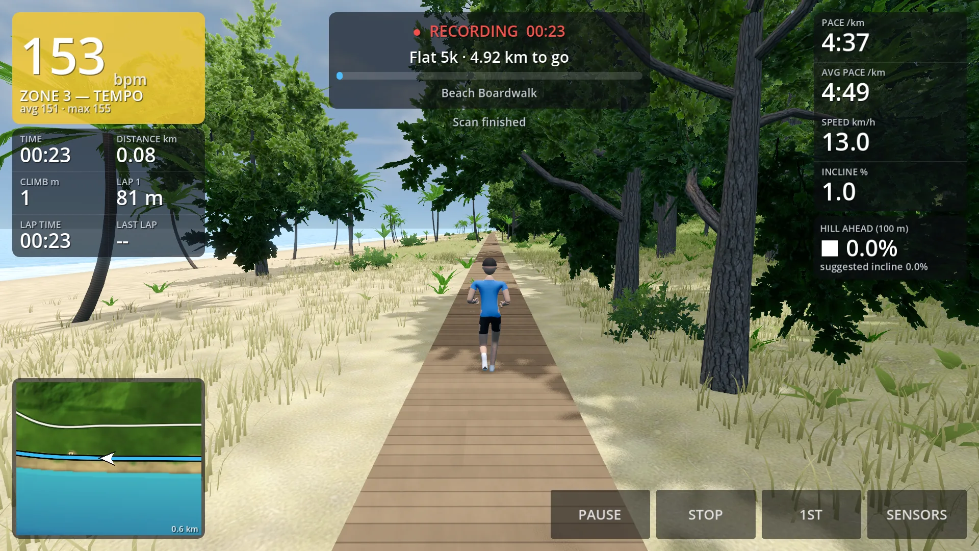 A runner on a wooden boardwalk along a beach, seen from behind, with heart rate and zone, time and distance, pace, the hill ahead and a minimap on the screen.