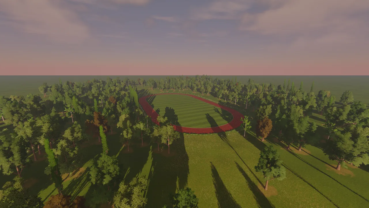 The whole track in its parkland from the air, trees casting long shadows.