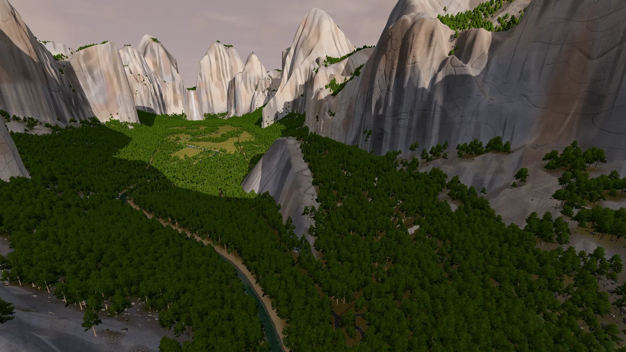 The lower valley from the air, the river running through forest between the walls.